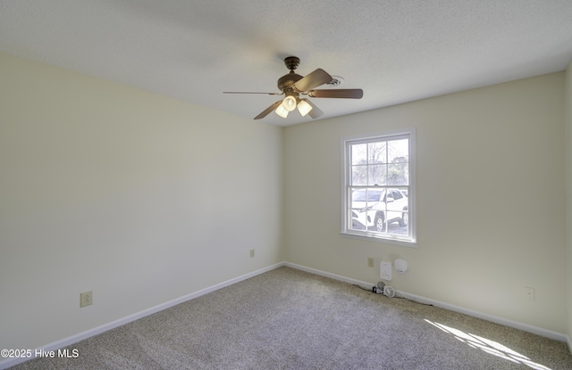 spare room with ceiling fan, carpet floors, a textured ceiling, and baseboards