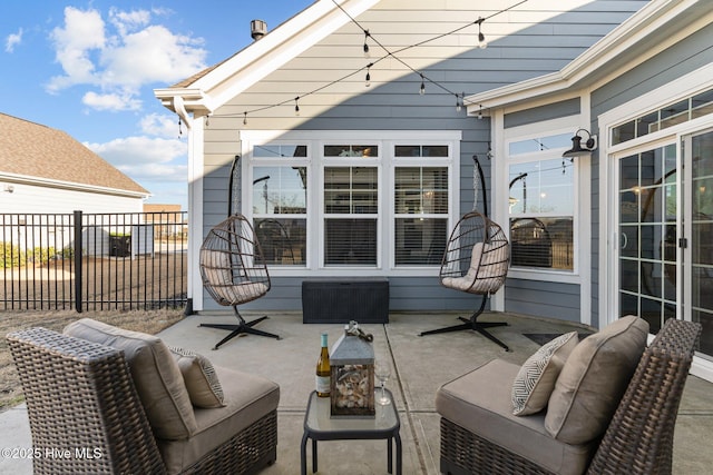 view of patio with outdoor lounge area and fence