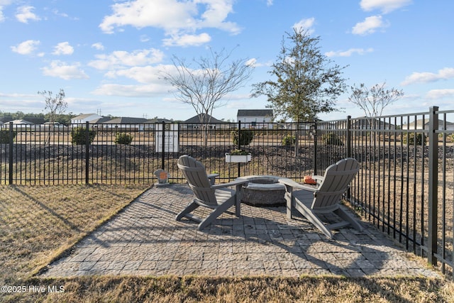 view of yard featuring a fire pit, a patio, and fence