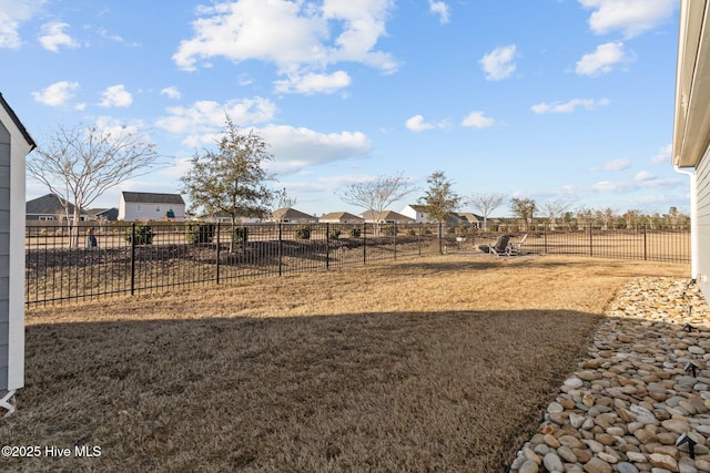 view of yard featuring a residential view and fence