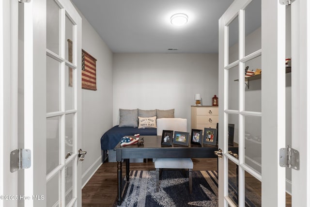 home office with french doors, baseboards, visible vents, and wood finished floors