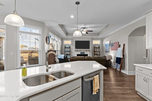 kitchen with ceiling fan, dark wood finished floors, dishwasher, light countertops, and a sink