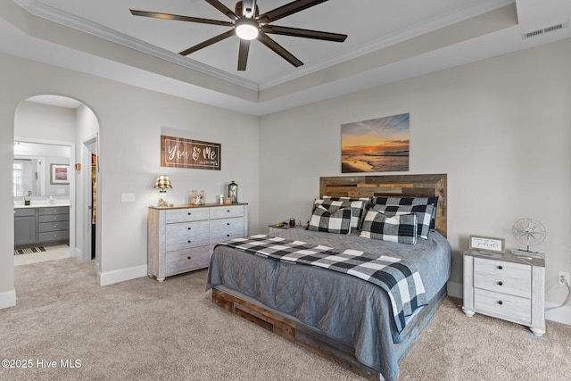 carpeted bedroom with arched walkways, visible vents, a raised ceiling, and ornamental molding