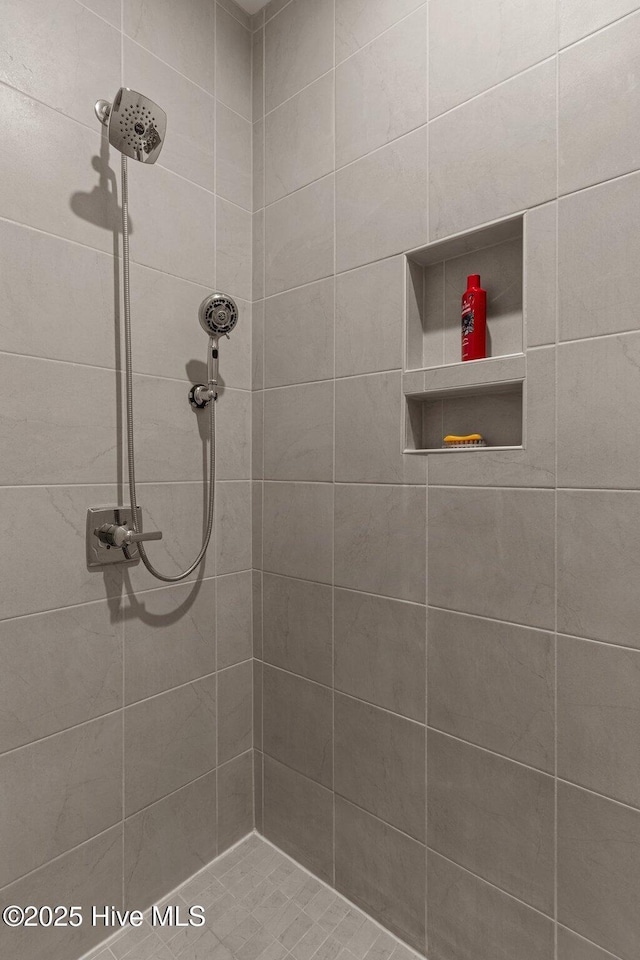 bathroom with tiled shower