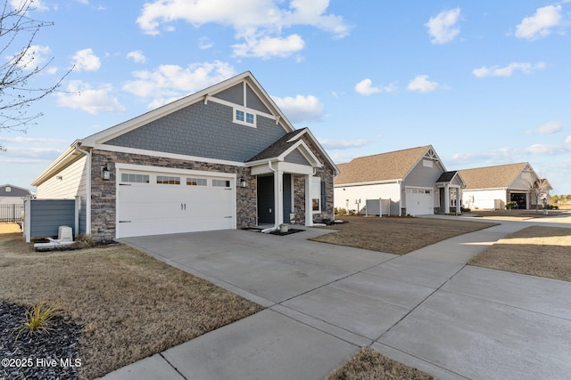 view of front of home with stone siding, an attached garage, and concrete driveway