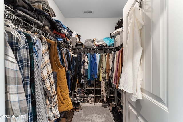 spacious closet featuring visible vents and carpet floors