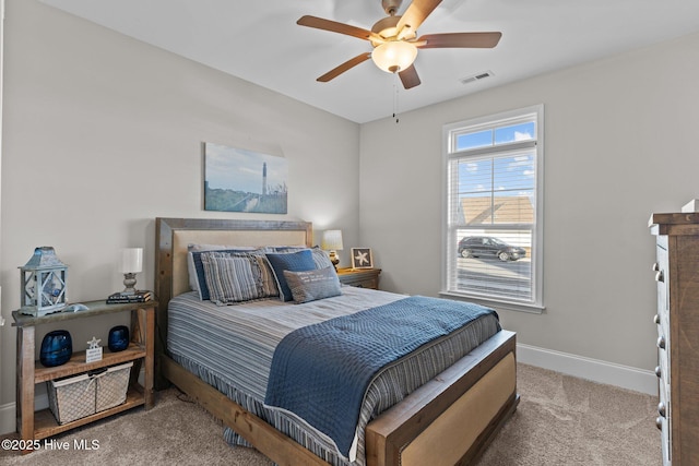 bedroom featuring carpet flooring, baseboards, visible vents, and ceiling fan