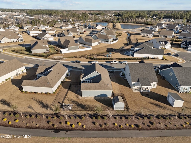 bird's eye view featuring a residential view and a water view