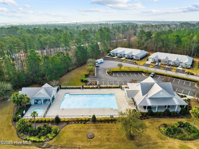birds eye view of property featuring a view of trees