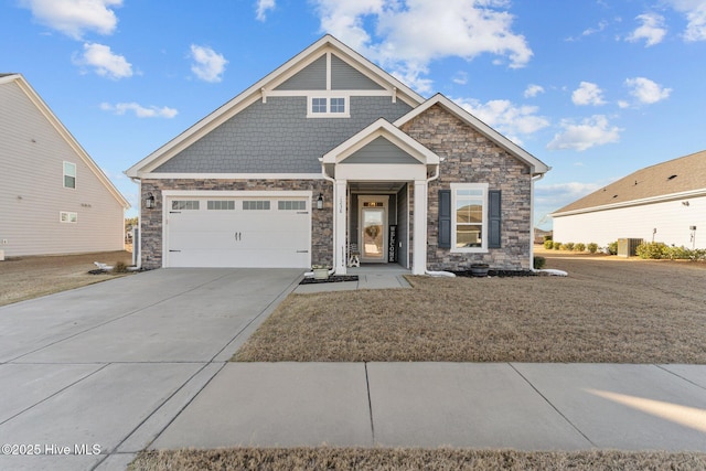 view of front facade with stone siding, an attached garage, driveway, and a front yard