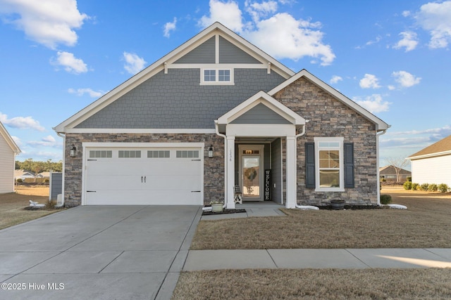 view of front facade with stone siding, driveway, and an attached garage