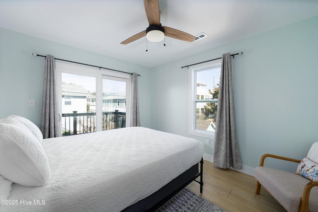 bedroom with light wood-style flooring, visible vents, a ceiling fan, baseboards, and access to outside