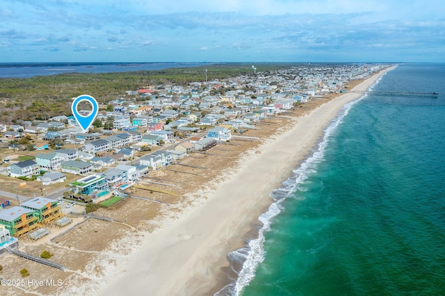 drone / aerial view with a beach view and a water view