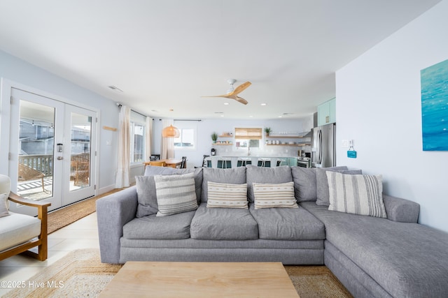 living area with a ceiling fan, recessed lighting, french doors, and visible vents