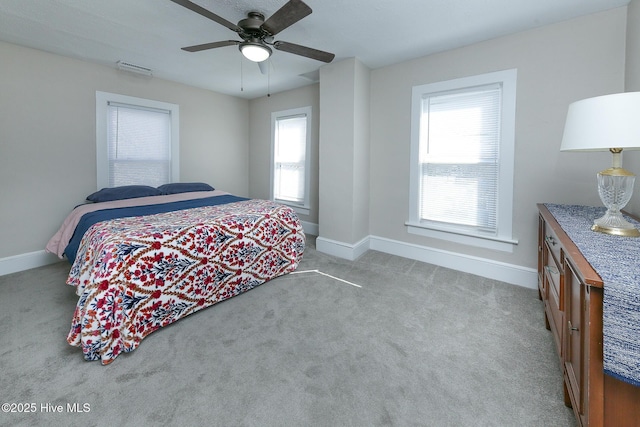 carpeted bedroom with baseboards and a ceiling fan