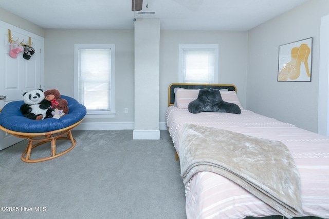 carpeted bedroom featuring visible vents and baseboards