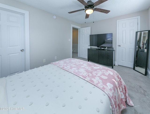 bedroom featuring light carpet and ceiling fan