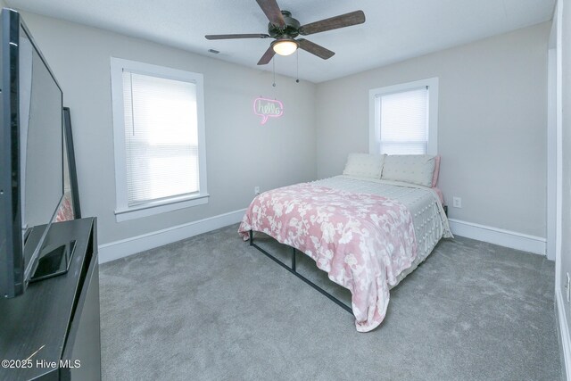 bedroom with carpet floors, visible vents, ceiling fan, and baseboards