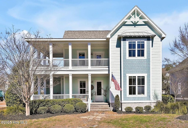 view of front of home with a balcony, a shingled roof, and a porch