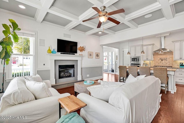 living room with coffered ceiling, a glass covered fireplace, dark wood-type flooring, beamed ceiling, and recessed lighting