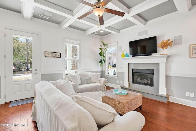 living area with hardwood / wood-style flooring, visible vents, and beamed ceiling