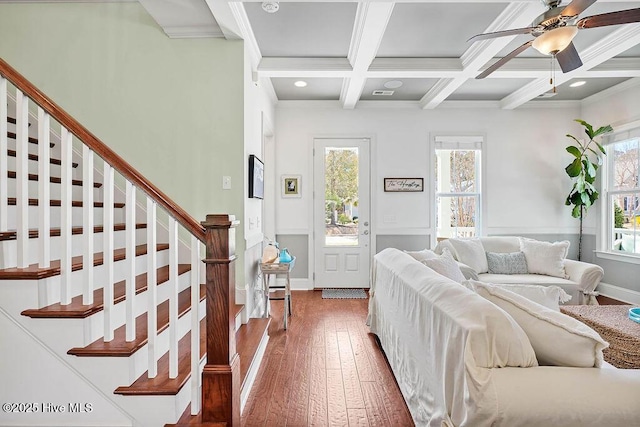 interior space with beamed ceiling, coffered ceiling, wood-type flooring, and a healthy amount of sunlight