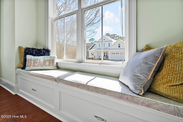 sitting room with dark wood-type flooring, a residential view, and baseboards