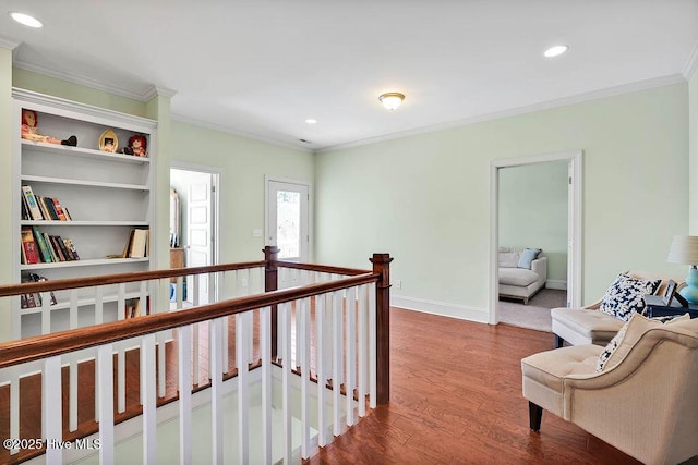 hall with baseboards, recessed lighting, wood finished floors, and crown molding