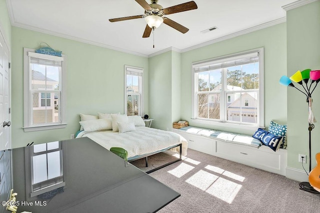 bedroom with visible vents, crown molding, carpet flooring, and multiple windows