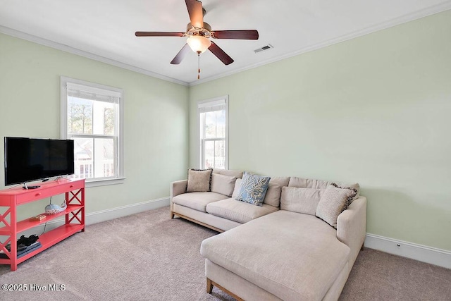 living area with ceiling fan, carpet floors, visible vents, baseboards, and ornamental molding