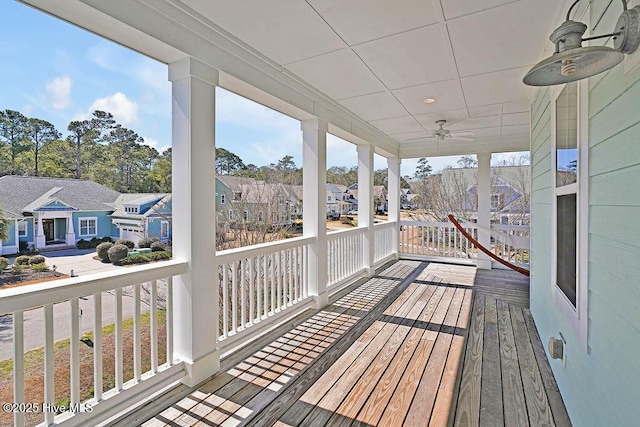 wooden deck featuring ceiling fan and a residential view