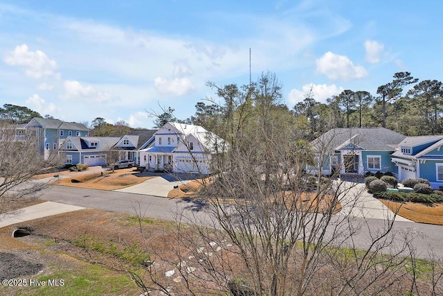 exterior space with a residential view and concrete driveway