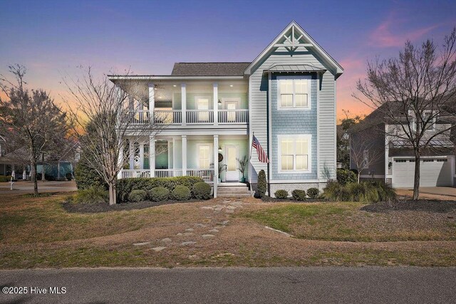 view of front of home featuring a porch, metal roof, and a balcony