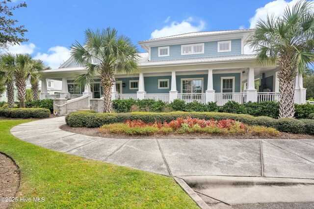 view of front of house with covered porch and french doors