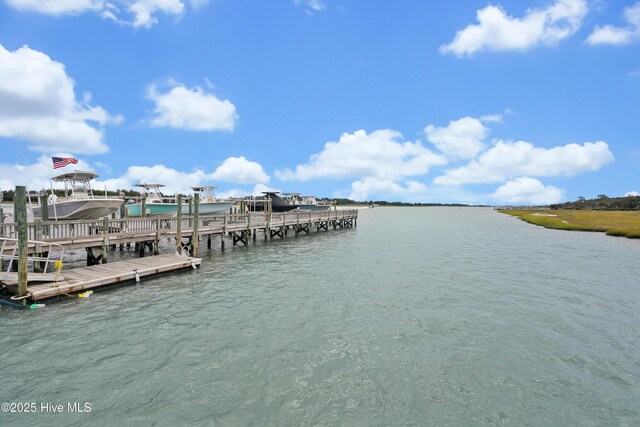 dock area with a water view and boat lift