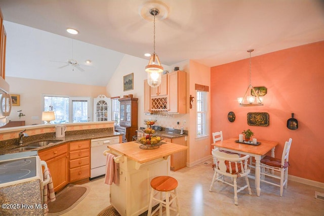 kitchen featuring white appliances, visible vents, butcher block countertops, a sink, and pendant lighting