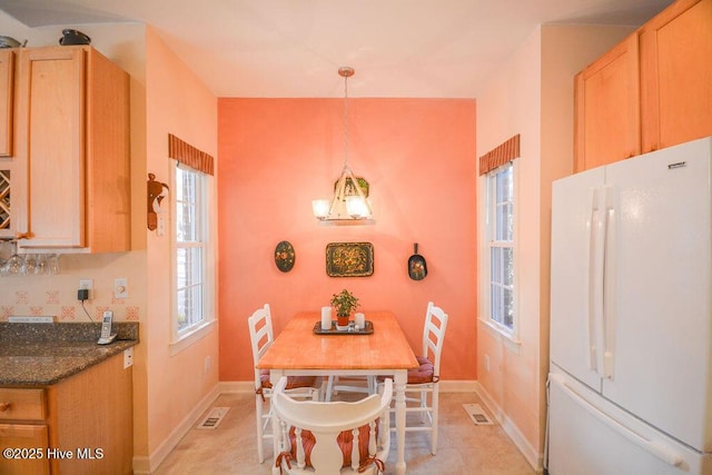 dining space featuring visible vents and baseboards