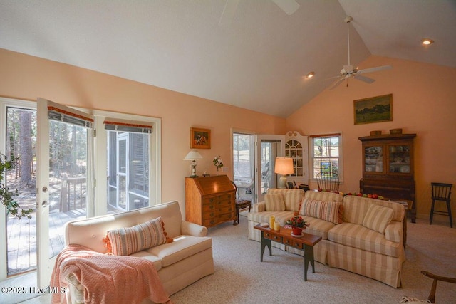 living area with a ceiling fan, carpet, and high vaulted ceiling