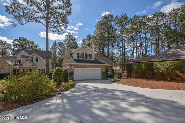 view of front facade featuring concrete driveway, an attached garage, brick siding, and crawl space