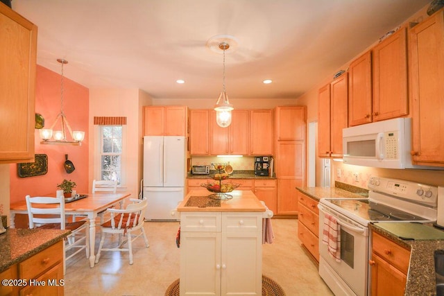 kitchen featuring recessed lighting, white appliances, a kitchen island, and pendant lighting