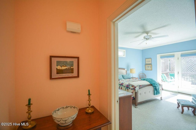 carpeted bedroom featuring access to exterior, a textured ceiling, a ceiling fan, and ornamental molding