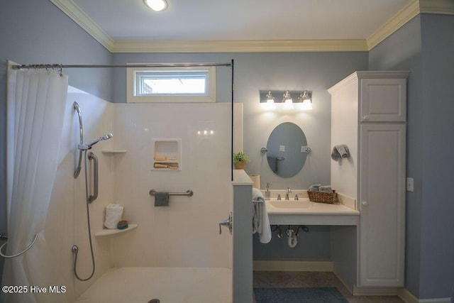 bathroom featuring a shower with shower curtain, ornamental molding, and a sink