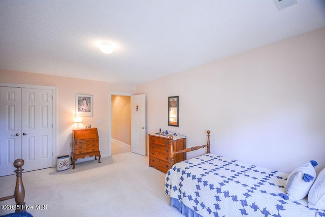 bedroom featuring a closet, visible vents, and carpet