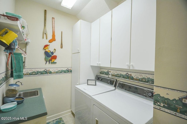 washroom featuring a sink, cabinet space, and washer and clothes dryer