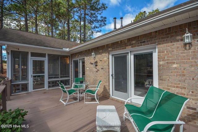 wooden deck with a sunroom