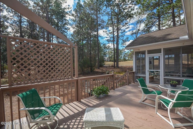 wooden deck with a sunroom