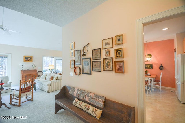 living room with baseboards, high vaulted ceiling, recessed lighting, ceiling fan, and light carpet