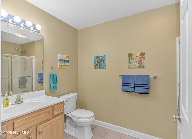 full bathroom featuring baseboards, toilet, a shower with door, tile patterned flooring, and vanity