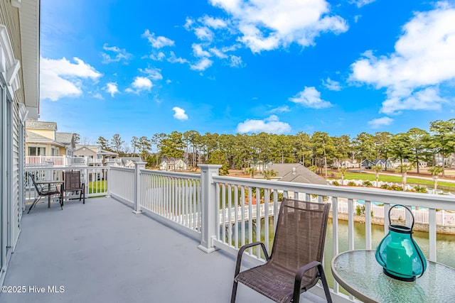 balcony featuring a water view and a residential view