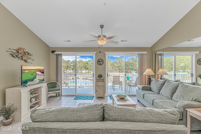 tiled living area featuring visible vents, vaulted ceiling, and a ceiling fan